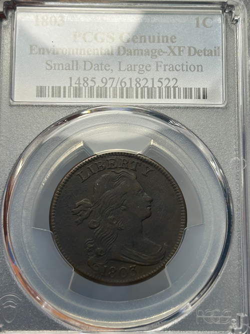 Coin in a protective case with grading information on a clear background